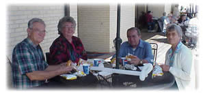 Shown from left, A. J. and Catherine Taylor, of Magnolia, Texas, and Graceville and Robert and Martha Wilkin of Chipley enjoy complimentary barbeque sandwiches at WFECs Member Appreciation Day and Annual Meeting.